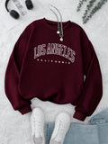 Front view of INAWLY womens casual burgundy crewneck sweatshirt with letter print