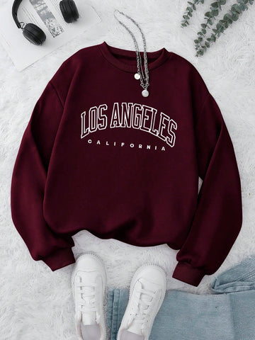 Front view of INAWLY womens casual burgundy crewneck sweatshirt with letter print